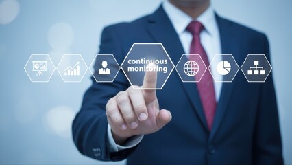Businessman in suit interacting with a technology interface displaying charts and continuous monitoring icons