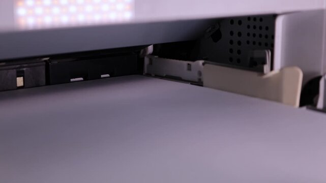 Printer prints document in stages from start to finish in a well-lit office setting