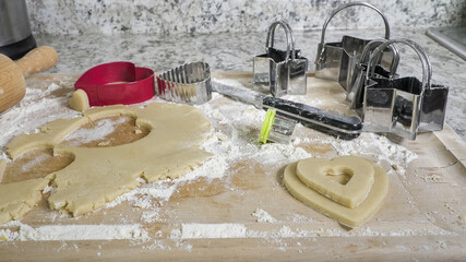 Preparing homemade heart shaped cookies and dough for baking