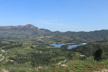 Fototapeta premium Mountain landscape with reservoir and green valleys, panoramic countryside nature view