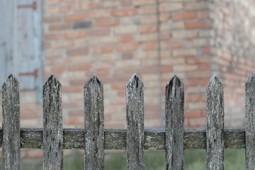 Wooden rotten fence around the house.Influence of weather conditions on wood.