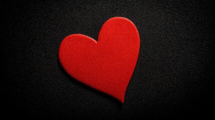 Obraz premium devotion. Minimalist red heart on a textured black surface, symbolizing love and gratitude. wellbeing guides, coaching materials, designed for mental health education and mindfulness programs. 