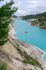 Obraz premium White Chalk Cliffs Above Turquoise Quarry Lake