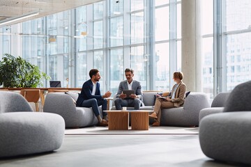 Fototapeta premium Diverse Business Team Collaborating in Modern Office Lobby