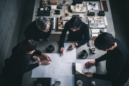 Architects and designers collaborating on innovative building project with scale models