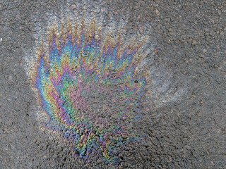 Fototapeta premium Background of oil spill on asphalt