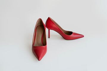 Matte red stiletto heels on an isolated white background. Stock photo