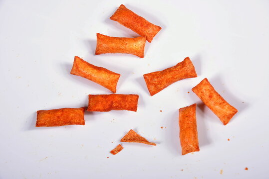 Top view of a plate of corn cookies with tomato and chilli flavored filling on a white background (cuscinetti croccanti)