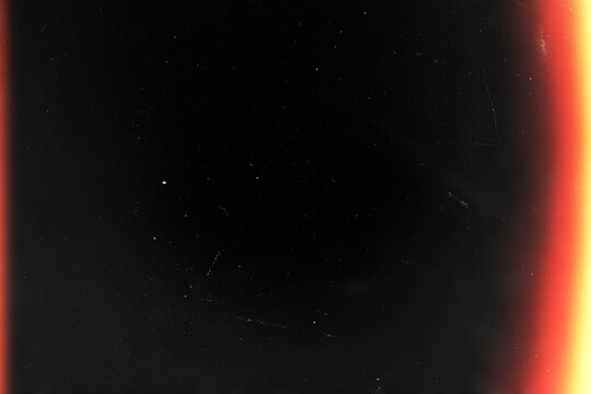 light leaks overlay effect with dust and blurred orange light.retro film Cinematic flare light leak on a black background.abstract analog film burn ray light.Leaked camera poster photo effect mockup