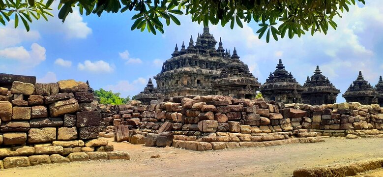 Panoramic view of Plaosan Temple with ancient stone ruins and blue sky in Klaten, Indonesia.