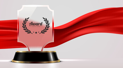 Prestigious glass award trophy with red ribbon background.