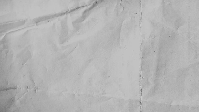 Grey Crumpled Paper Tearing Open to Reveal Black Background.top motion animation of crumpled grey paper texture tearing apart to reveal black copy space for transitions.