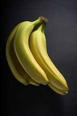 beautiful banana branch photographed on a black background