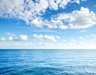 Obraz premium A serene seascape portrays a vibrant blue ocean meeting a partly cloudy sky. The tranquil water stretches to the horizon beneath scattered fluffy white clouds