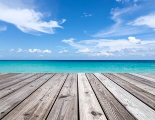 Obraz premium A serene seascape with a weathered wooden boardwalk leading towards a turquoise ocean under a bright blue sky filled with wispy clouds. A picture of tranquility
