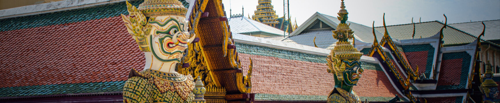 Two yaksha statues from the Ramakien epic guard the gates of Wat Phra Kaew in Bangkok.