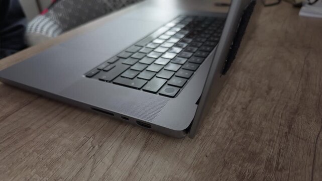 Close up of hand using touch id to unlock computer with visible display