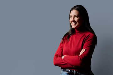 Profile portrait of beautiful confident 40 years old woman in red sweater on gray background © Valerii Honcharuk