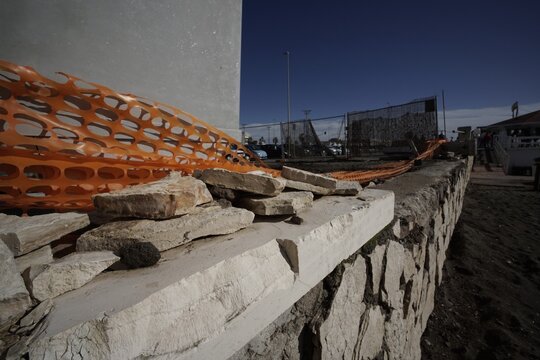 Ostia, Rome, Italy - January 25, 2026, detail of a section of a retaining wall in opus incertum travertine with perspective view.