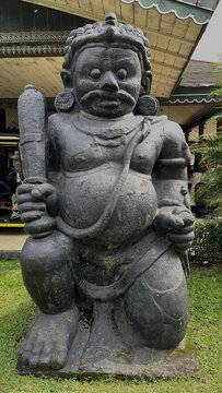Ancient Dwarapala statue, traditional stone temple guardian in Java, Indonesia. Majestic sculpture representing ancient mythology and Indonesian cultural heritage