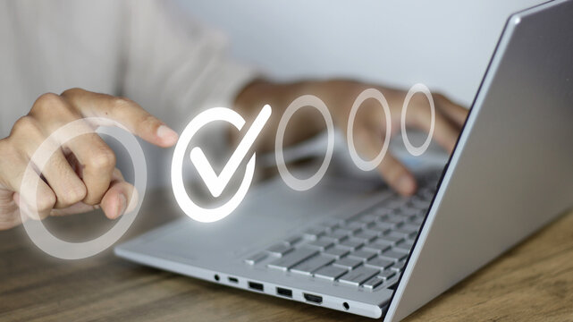 Digital verification process in action. A professional uses a laptop to complete online surveys and compliance tasks, ensuring data accuracy and quality control through a seamless virtual interface