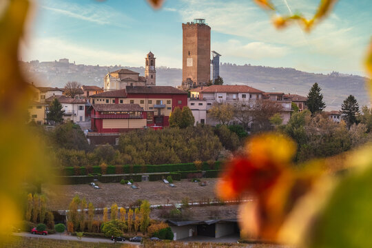 Hilltop villagescape view through autumnal leaves, Neive, Langhe, Piedmont, Italy
