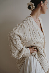 Woman Standing Sideways In Textured Knit Cardigan For Cozy Home And Relaxation Concept