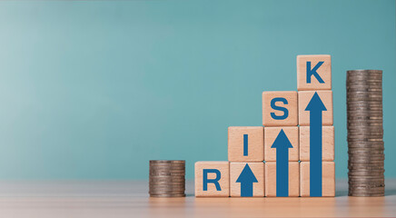 Investment risk and financial concept with wooden blocks forming rising arrows and word risk, next to stacked coins for related of business risk and profit return concept.