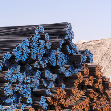 Close-up of stacks of blue and orange colour coded steel bars