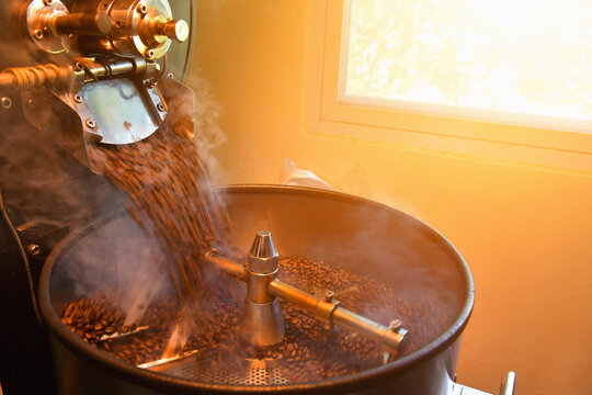 Close-up of coffee beans roasting in a factory roasting machine, Thailand