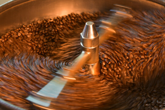 Close-up of Coffee beans roasting in a factory coffee roaster, Thailand