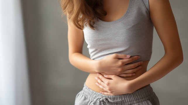 Young Woman Holding Stomach in Pain, Abdominal Pain and Digestive Problem Concept, Female Health, Gastrointestinal Disorder, Menstrual Cramps, Medical and Healthcare Background