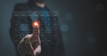 Businessman hand selecting important dates to digital calendar representing reminder time management planning ,appointments and project deadlines Business and scheduling concept.
