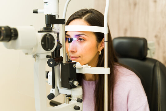Woman getting professional eye exam with a slit lamp by an ophthalmologist, checking vision