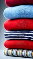 Stacked colorful knitwear folded red, blue, striped sweaters and comfortable tops for every season