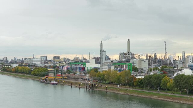 Chemical plant industrial complex emitting smoke on rhine river