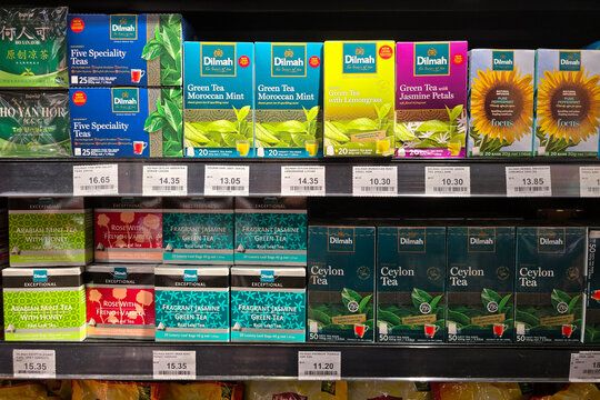 Penang, Malaysia: Nov 06, 2025: A retail display showcasing various Dilmah tea flavors including Ceylon, Green Tea and Jasmine, alongside Ho Yan Hor herbal tea boxes on a grocery store shelf.