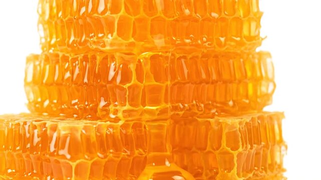 Healthy organic honeycomb texture with yellow golden beeswax cells isolated on a white background, featuring a sweet natural macro pattern of fresh golden honey