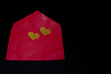 Conceptual still life motives for Valentine's Day featuring romantic elements like hearts  and gift boxes. The composition use a low-key lighting technique against a solid black background.