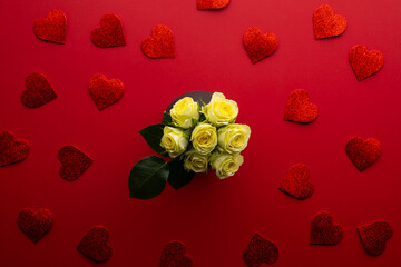 Roses and heart shapes on a red background arranged for a special occasion
