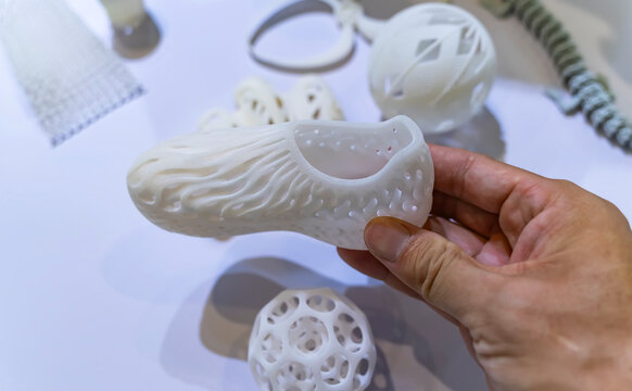 hand with 3d printed shoe figure close-up