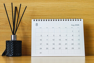 Office desk calendar showing August 2026 with copy space on wooden background, ideal for business planning, scheduling, and time management concepts.
