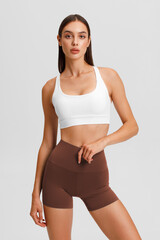 Fototapeta premium Athletic girl on the gray background. Fitness woman