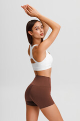 Fototapeta premium Athletic girl on the gray background. Fitness woman