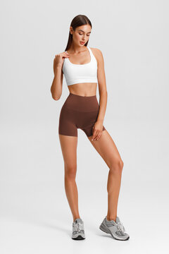 Athletic girl on the gray background. Fitness woman
