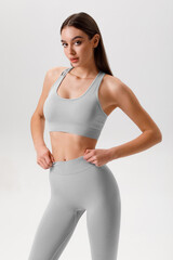 Fototapeta premium Athletic girl on the gray background. Fitness woman
