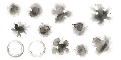 A collection of artistic grey watercolor stains and ink splatters for grunge design elements