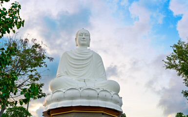 Big Buddha statue, Nha Trang Vietnam. Big White Buddha on the background of foliage and sky.