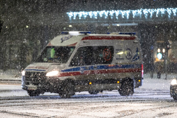 Karetka medyczna w śniegu zimą na sygnale alarmowo © FotoDax