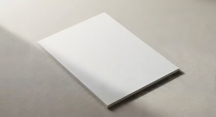 Simple white notepad on a light gray surface in a well-lit room showcasing Scandinavian minimalism